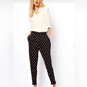 Black tapered-leg high-rise pull-on pants with white dots and side pockets